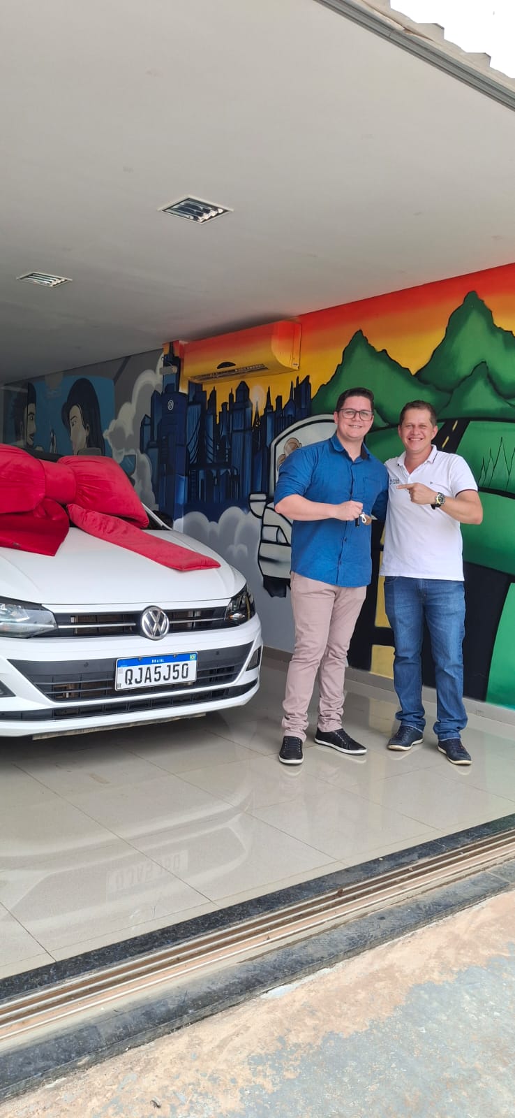 Cliente e representante ao lado de um carro branco